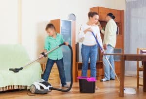 family of three doing housework together