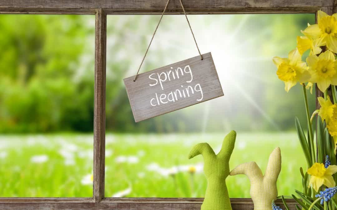 Sign With English Text Spring Cleaning. Window Frame With View To Beautiful Sunny Green Meadow. Easter Bunny